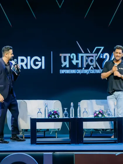 Interacting with MS Dhoni on stage. My approach is to be respectful yet conversational, creating a natural and engaging dialogue.