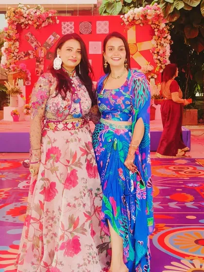 Posing with a happy guest on the vibrant, custom-designed dance floor of a sangeet I choreographed. The decor and the dance floor itself are part of the story we tell.