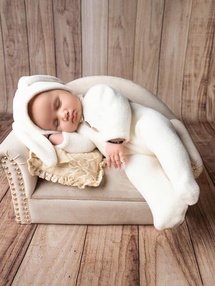 Sleeping peacefully in dreamland. I use simple props like this miniature bench to create a timeless and adorable scene for your newborn.