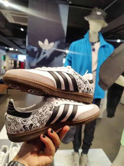 A pair of classic Adidas Sambas with a custom doodle art design, created during my live customization session.