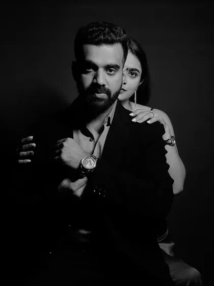 The power of a classic black and white portrait. This studio-style shot uses dramatic lighting to create a bold, sophisticated, and timeless image that focuses purely on the couple's powerful connection.