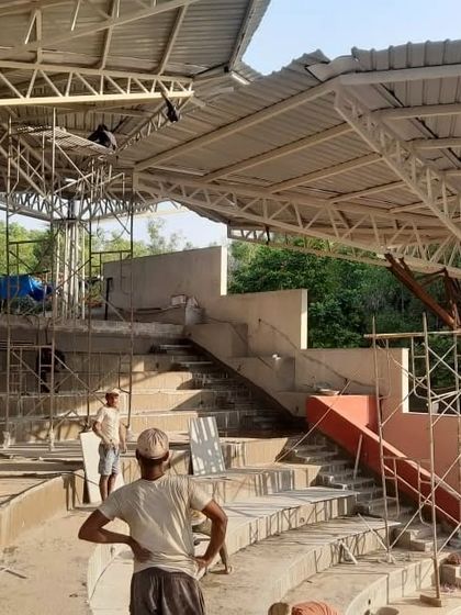 The steel superstructure for the bamboo parasols being erected at the TAPMI Centre. This image shows the engineered skeleton that supports the organic, crafted skin.
