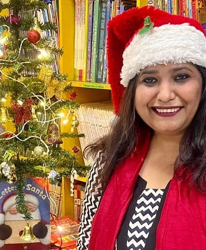 A portrait from our Christmas celebration, surrounded by books and festive decorations. It's a joy to host these events and share the holiday spirit with our community.