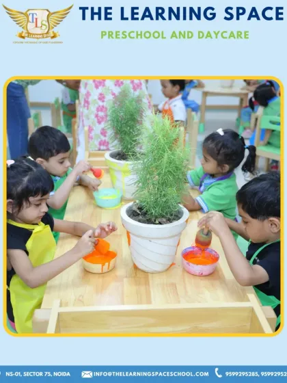 A group of children painting pots together. Collaborative art projects like this teach sharing, communication, and the joy of creating something beautiful as a team.