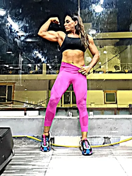 Flexing to show the connection between the bicep and shoulder. This is the result of not just lifting, but eating the right foods at the right times to support muscle growth.