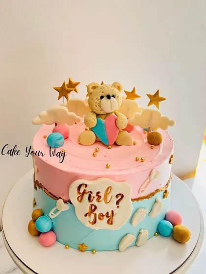 The cutest cake for the cutest baby-to-be. This gender reveal cake features a teddy bear holding a pink and blue heart.