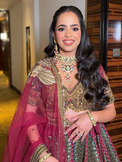 A close-up of the defined eyes and radiant skin that I created to match this stunning maroon and gold lehenga. The makeup is both glamorous and timeless.