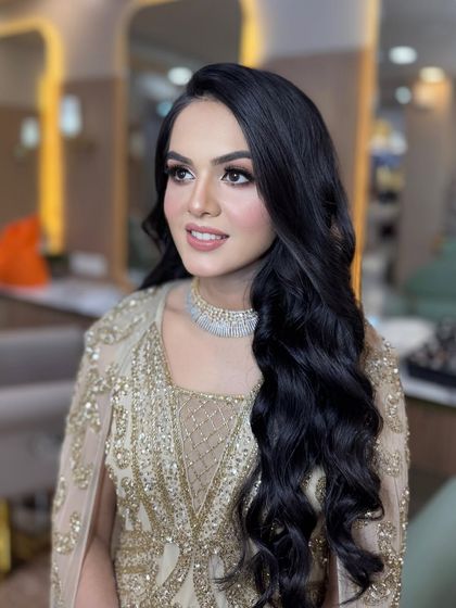 A side profile of this beautiful engagement look, showing off the soft curls and perfectly blended makeup.