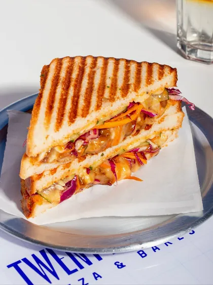 The Togarashi Chicken Melt Sandwich offers a unique Japanese-inspired flavour profile. It's filled with teriyaki glazed chicken, spicy yuzu slaw, and togarashi mayo.