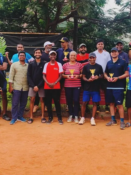 This is our community. A group photo of our players after a tournament day, all sharing the love for the game on our red clay courts.