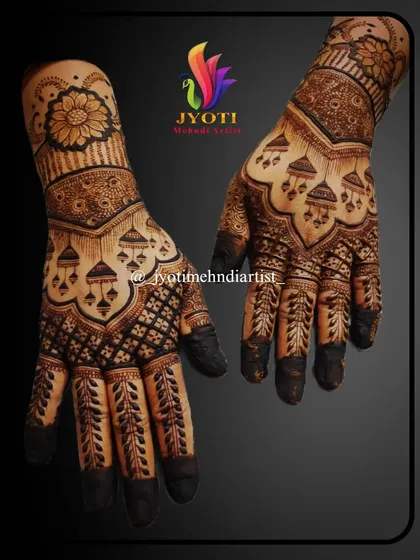 Traditional jhumka (earring) motifs hang delicately from a patterned canopy in this bridal design. The fingers feature leafy vines, and the wrist is adorned with a bold floral cuff.