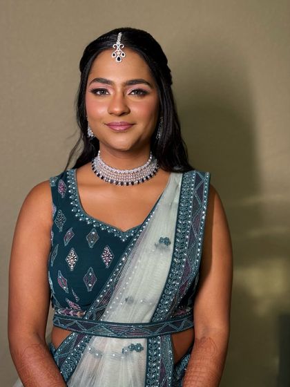 A full-length view of the teal lehenga, showing how the soft glam makeup complements the modern and stylish outfit.