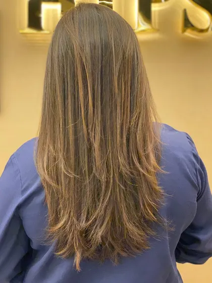 The back of a client's hair, showing the beautiful, long layers and healthy, shiny finish of her new cut.