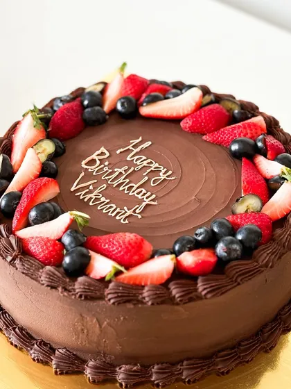 A classic combination of rich chocolate cake topped with fresh strawberries and blueberries. This cake is a testament to the simple joy of chocolate and delicious berries.