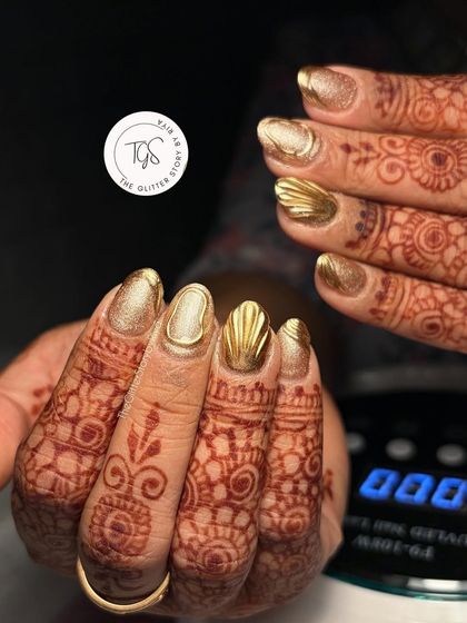 A full view of these gorgeous 3D shell-textured gold chrome nails. This look is perfect for a bride who wants something unique and glamorous to match her wedding attire.