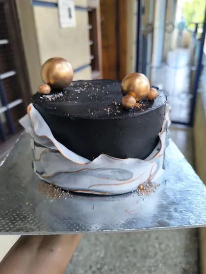 I tried a marble fondant wrap for the first time on this cake. I love the unpredictable and artistic pattern it creates, especially in this sophisticated black, white, and gold design.