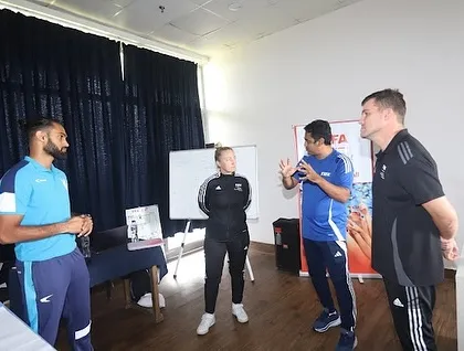 We believe in collaborative learning. This image shows an interactive discussion between coaches at the FIFA development event, sharing insights and strategies.