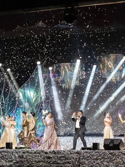 A grand performance on the sangeet stage, complete with confetti and dramatic spotlights. We manage all aspects of production to ensure every performance is a show stopping moment.