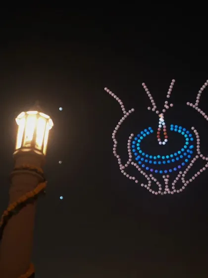 A diya held in protective hands, symbolizing the preservation of light and tradition. This was one of the many moving formations from our show at Delhi's Vasudev Ghat.