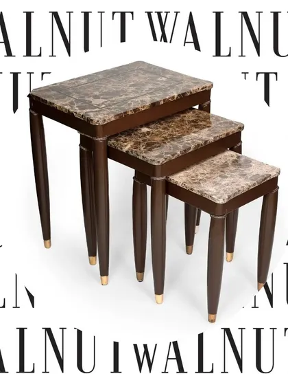 A sophisticated nest of three tables, handcrafted with premium wood and topped with brown marble. The tapered legs with brass tips add a dash of mid-century elegance to this versatile set.