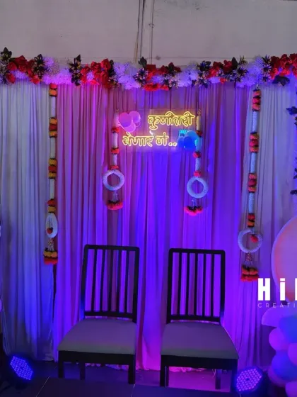 Another angle of the traditional baby shower seating arrangement with custom neon signage in Marathi.