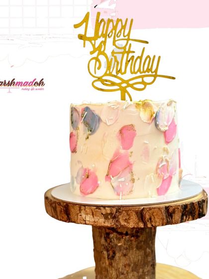 The full view of the tall, pink abstract cake, a perfect example of a modern and artistic celebration cake.