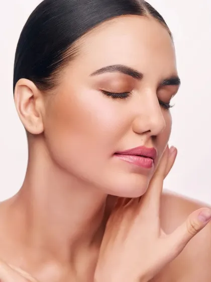 A serene beauty portrait with the model's eyes closed. This pose emphasizes the smooth skin texture and subtle makeup, creating a peaceful and gentle mood.