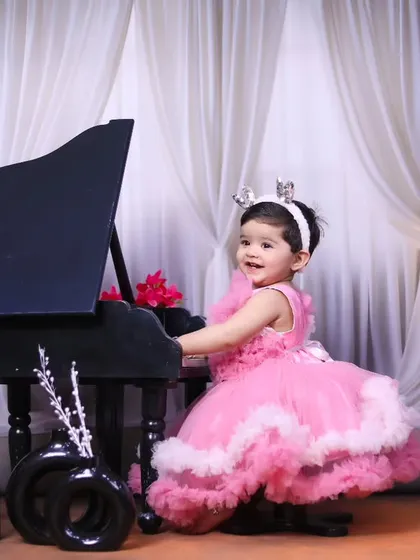 This little princess is having fun playing the piano during her themed session.