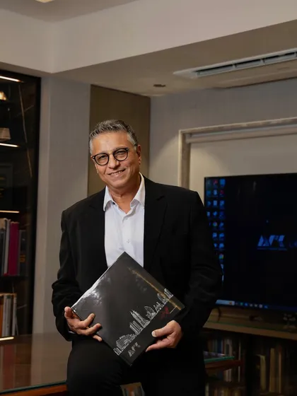 A portrait of me in my office. After 37 years of practice, my core philosophy remains the same: to liberate spaces and create designs that are a blend of artistry, function, and sustainability.