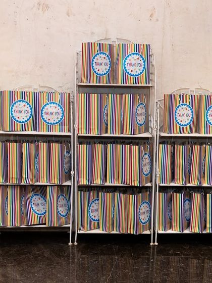 Neatly arranged, colorful return gift bags ready for guests at the end of the carnival party.