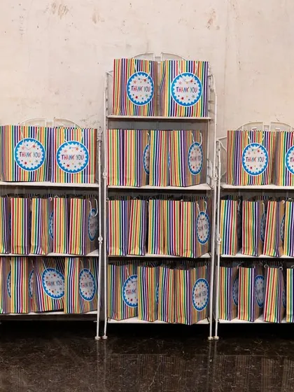 Neatly arranged, colorful return gift bags ready for guests at the end of the carnival party.