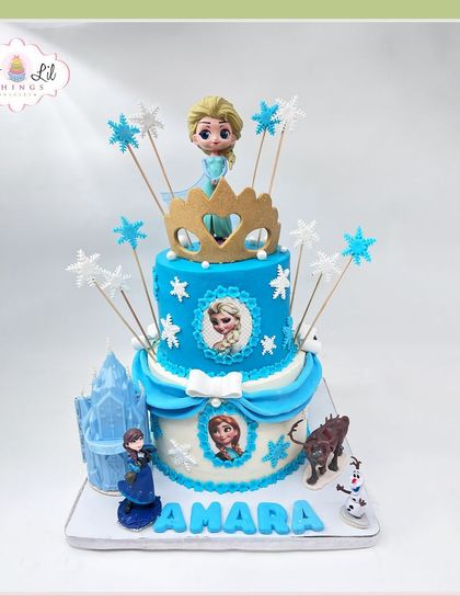 A grand Frozen-themed cake for Amara, complete with an ice castle, all the main characters, and snowflake details.