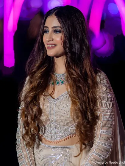 A glamorous look for a wedding guest, ready for an evening reception. The smokey eye and long, flowing hair create a dramatic and beautiful effect.
