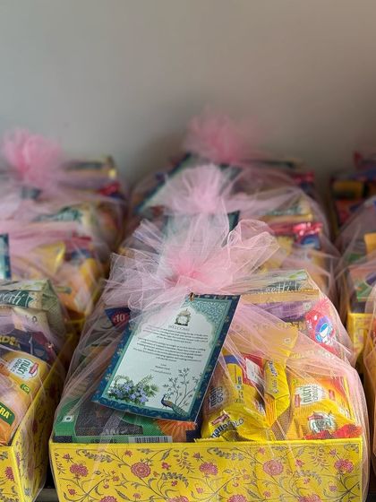 The final presentation of the guest welcome hampers, all wrapped up and ready to be placed in their hotel rooms. The custom card adds a warm, personal welcome.