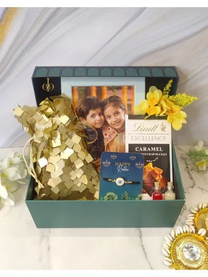 A truly personal Rakhi hamper that includes a photo frame with a sibling picture, along with Lindt chocolate and a beautiful Rakhi.