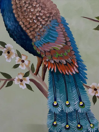 A detail shot of the peacock's body and the delicate flowers.