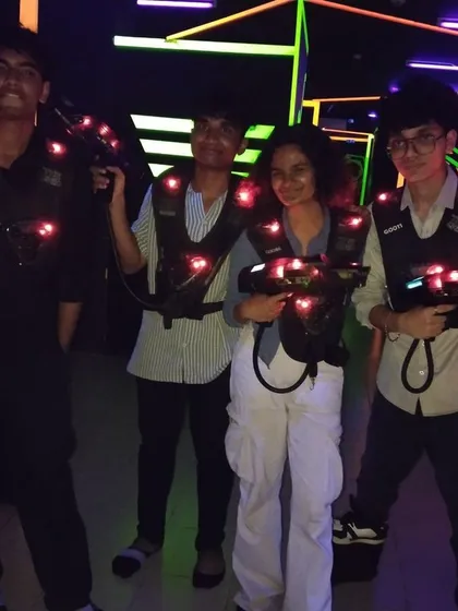 A group of young friends posing with their laser tag gear, ready for some fun.