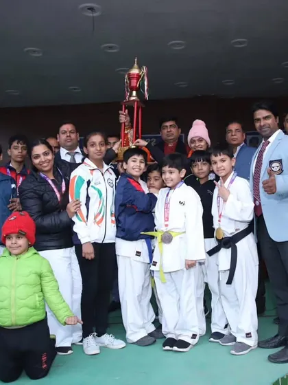 Posing with a trophy after a successful championship. These moments are the result of immense hard work and team spirit.