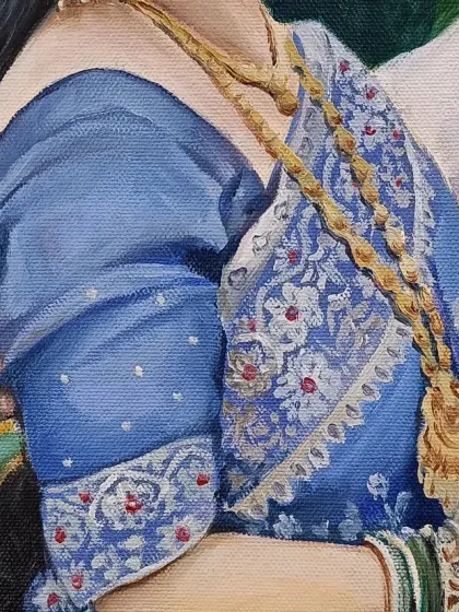 A close-up on the bride's blue saree and green bangles.