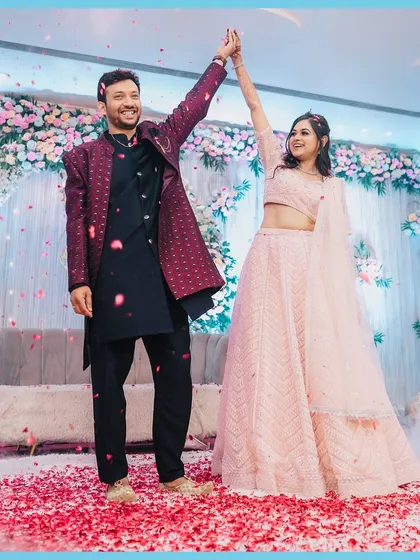 A joyous moment from the engagement, with the couple dancing under a shower of rose petals. Pure celebration.