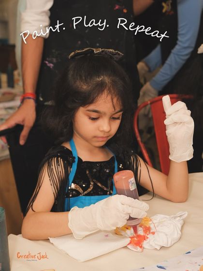 With the motto "Paint. Play. Repeat," this image captures a girl enjoying a tie-dye activity, a perfect example of the hands-on fun at my parties.