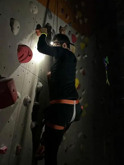 A climber uses his headlamp to spot the next hold during our after-dark climbing session.