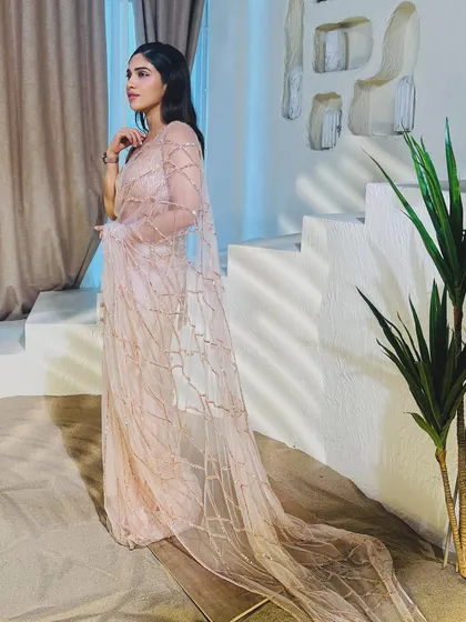 Pretty in pink! Here’s Bhumi Pednekar in a beautiful sequined saree by Masumi Mewawalla. This is a great option for a cocktail party or reception, offering sparkle and modern elegance.