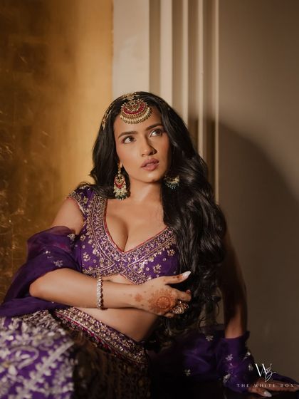 Shubhangi’s Sangeet look was a royal affair in purple. We created a bold eye look with glowing skin to match the grandeur of her Gopi Vaid outfit.