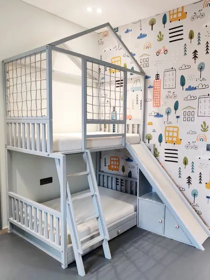What's better than a bunk bed? A bunk bed with a slide! I designed this custom house-frame bunk bed to be the ultimate playhouse, complete with a safe ladder, a fun slide, and storage drawers underneath. It’s all about making bedtime something to look forward to.