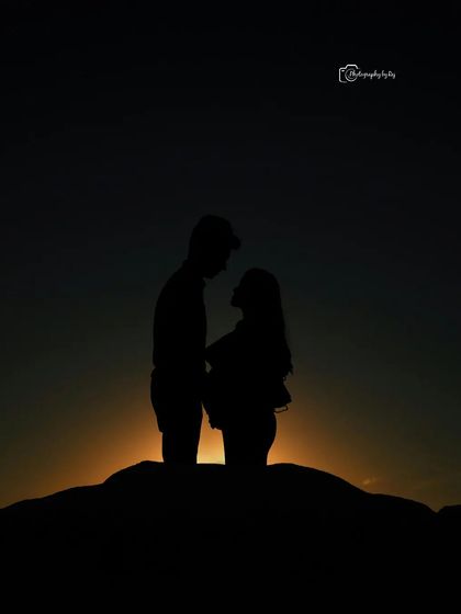 A dramatic silhouette of a couple against a setting sun, creating a powerful and emotional image.