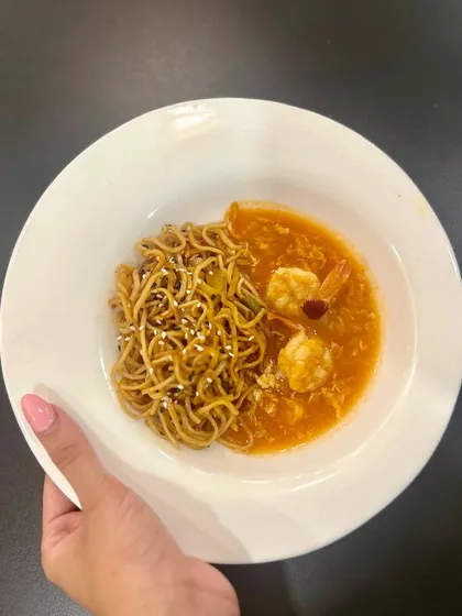 A delicious bowl of Singapore Chilli Prawns served with noodles, a perfect balance of sweet, spicy, and savoury.