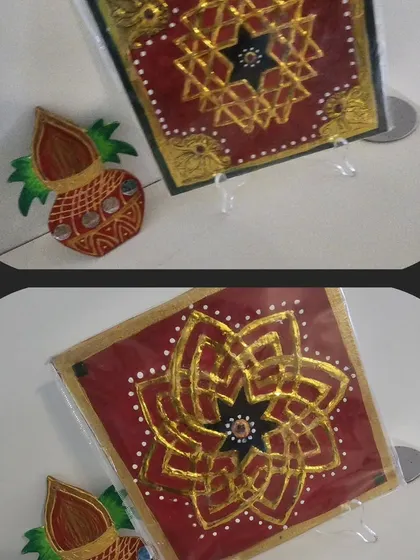 A beautiful handmade Diwali gift set. This includes a small, intricately painted rangoli-style plaque and a decorative kalash, perfect as a small token for the festive season.