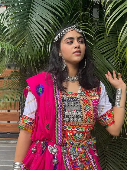A beautiful portrait in a traditional pink and white chaniya choli. The silver jewelry and headpiece complete this classic and elegant look.