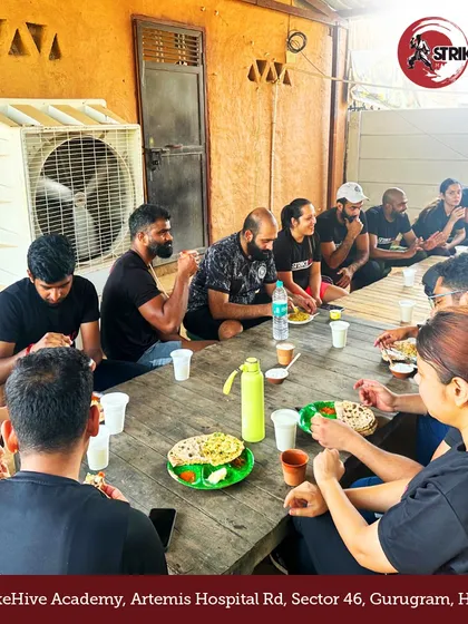 More than training, it's a family. Our members share a meal together during a team retreat, strengthening bonds off the mat.